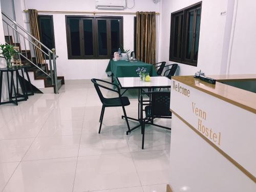 an empty room with a table and chairs in it at Venn Hostel in Vientiane