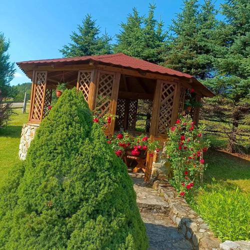a gazebo with a table in a garden at Ubytování ve Mlýně in Kladenské Rovné