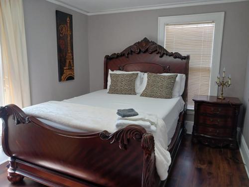 a bedroom with a large bed with a wooden frame at Best value 4 Huge Bedrooms in Willmar