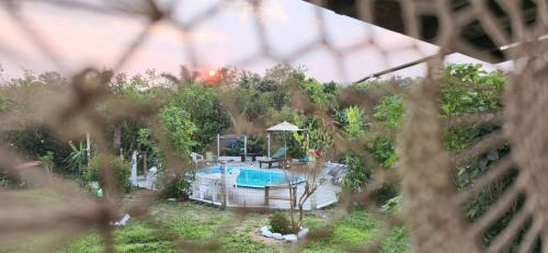 a view of a backyard with a swimming pool at Pousada Jardim da Lagoa in Garopaba