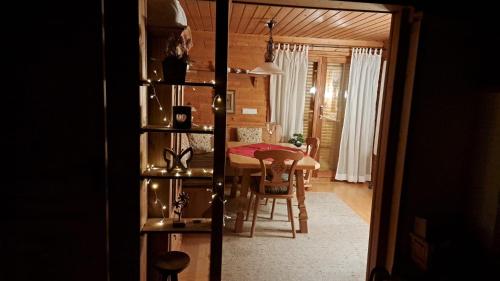a kitchen and dining room with a table and chairs at Chalet Spessart in Dammbach