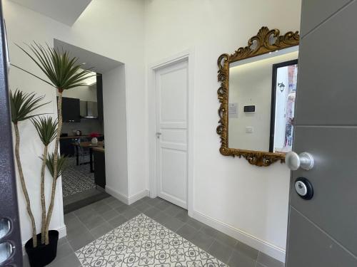 a mirror on a wall next to a hallway at Sangue blu - apartments in Catania