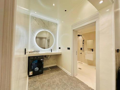 a bathroom with a sink and a mirror at Art Apartments Karbala in Karbala