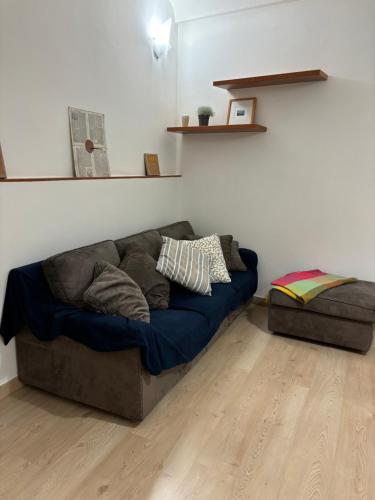 a couch sitting in a room with a wooden floor at Casa Luna in Ventimiglia