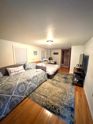 a living room with a bed and a couch at ANNABESSACOOK RETREAT LIMIT 8 home in Winthrop