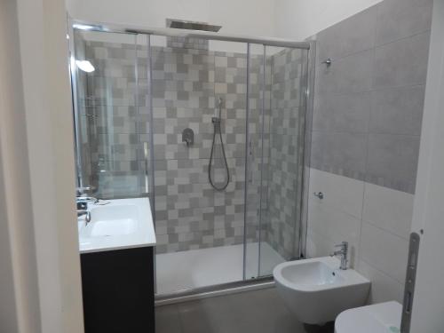 a bathroom with a shower and a sink and a toilet at Bellini's House in Montecatini Terme