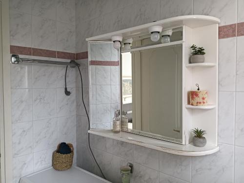 a bathroom with a mirror and a sink at Artemis sea house in Porto Rafti