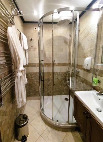 a bathroom with a shower and a sink at 7 Pools SPA Boutique Hotel in Bansko