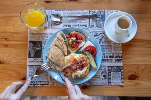 a person holding a plate of breakfast food and a cup of coffee at Finca Marisa in Tinajo