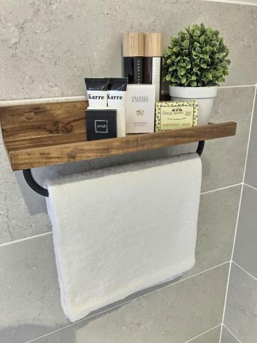 a wooden shelf with toilet paper and plants on it at The Blue Door in Letterkenny