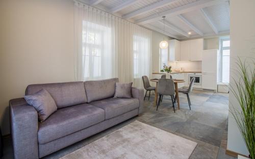 a living room with a couch and a table at Lai Residence Apartment 3 with Sauna in Tartu