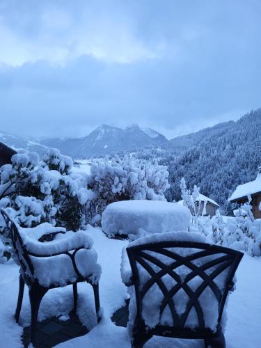 a couple of benches covered in snow at Couples Gem - Sensational views Nr Morzine in La Côte dʼArbroz