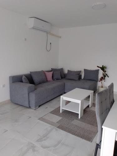 a living room with a couch and a coffee table at Vila Milica in Kladovo