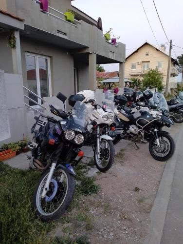 a row of motorcycles parked outside of a house at Vila Milica in Kladovo