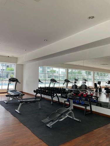 a gym with several treadmills and a large mirror at Meridin Bayvue - 3BR - 6 Pax - Near MMHE in Kampong Kuala Masai