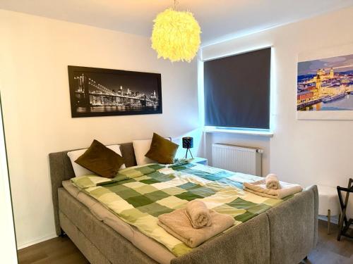 a bedroom with a bed with towels on it at Ferienappartment in zentraler Lage Passau in Passau