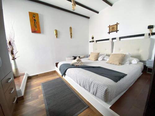 a bedroom with a large white bed in a room at Finca Marisa in Tinajo