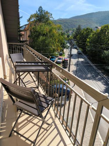 a balcony with two chairs and a table at Smestaj Dzentlmen in Soko Banja
