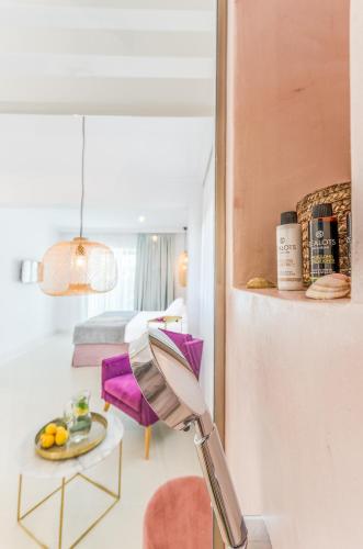 a room with a purple chair and a table at Comfort Rooms by MaliaMare Hotel in Malia