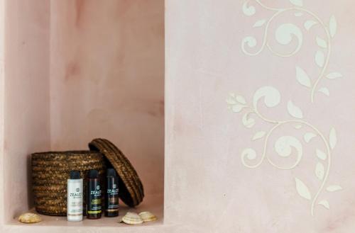 a shelf with bottles of wine next to a wall at Comfort Rooms by MaliaMare Hotel in Malia
