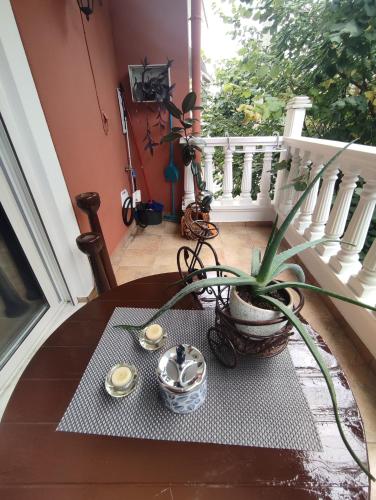 a table with a plant sitting on a porch at LD Studio Larissa in Larisa