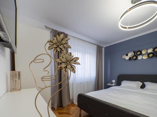 a bedroom with a bed and a flower sculpture at MSC Apartment in Sibiu