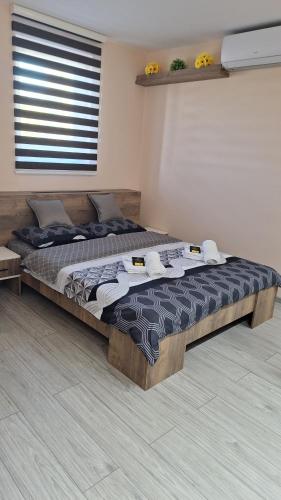 a bedroom with a large bed in a room at Apartments Green Beograd in Borča