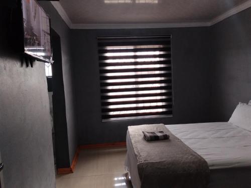 a bedroom with a bed and a window at Monarca inn - Affordable Accomodation in makwane molapo location Qwaqwa in Phuthaditjhaba