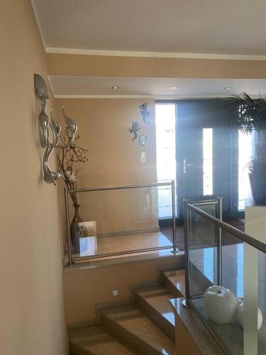 a staircase in a house with a glass railing at Villa Kaja 1 - Kamin - Pool - traumhafter Seeblick in Delecke
