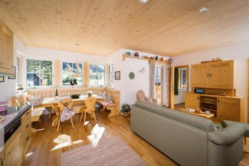a kitchen and living room with a couch and a table at Narzissendorf Zloam Apartments in Grundlsee