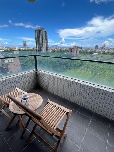 a balcony with a table and chairs and a view at Sunrise Hot Spring House in Toucheng