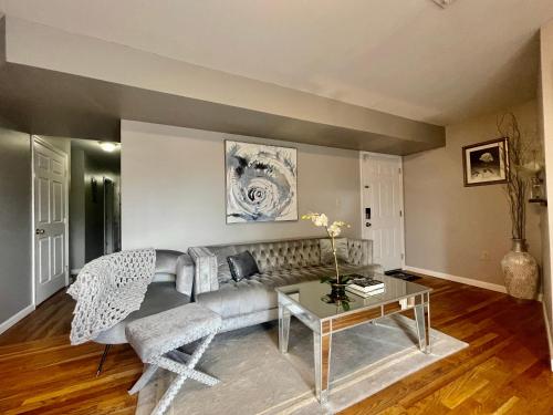 a living room with a couch and a table at 4 bedroom apt in Newark in Newark