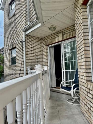 a porch with a white railing on a house at 4 bedroom apt in Newark in Newark