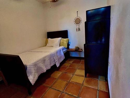 a bedroom with a bed and a black cabinet at La Kolina Reserve in Ponce