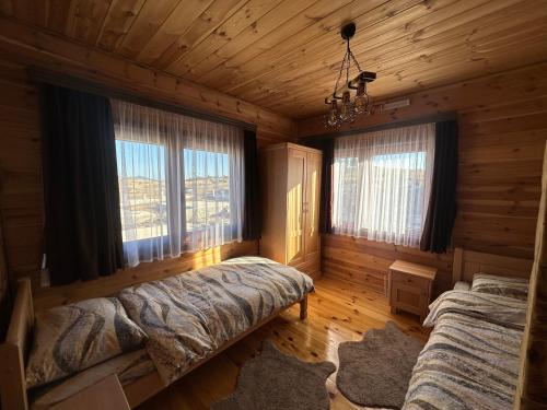a bedroom with two beds in a log cabin at Zagrad Homes in Zabljak in Žabljak