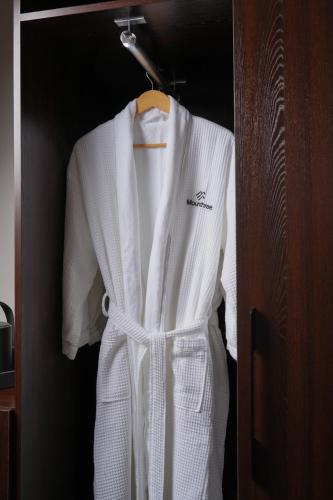 a white robe is hanging in a closet at Mounthree in Pʼambak