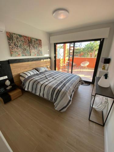 a bedroom with a large bed and a balcony at Penthouse Palapagolf in Orihuela Costa