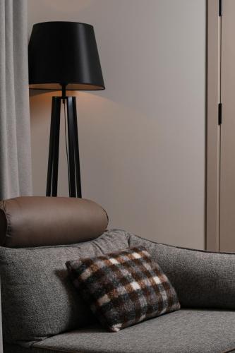 a lamp sitting on top of a couch with a pillow at Mounthree in Pʼambak