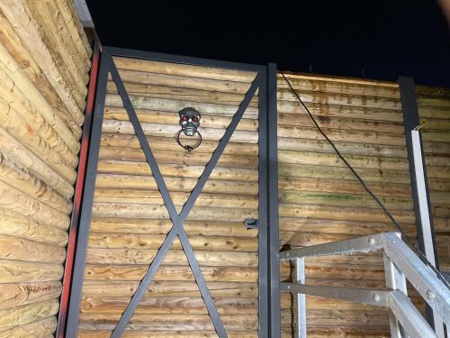 a door to a wooden building with a light on it at Cosy Little Loft in La Roche en Ardenne in La Roche-en-Ardenne