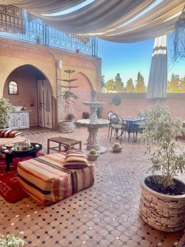 a courtyard with a fountain and a table and chairs at KOUTOBIA ROYAL in Marrakech