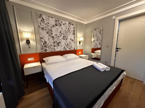 a bedroom with a large bed and two mirrors at OTTO Tunalı Houses in Ankara