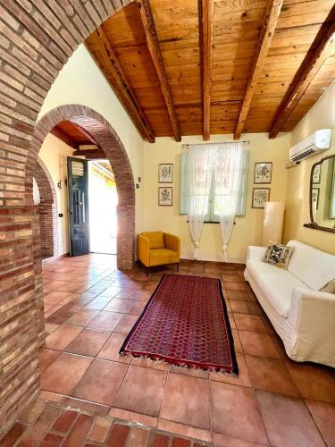 a living room with a couch and a brick wall at Case Di Loco Castro in Agnone Bagni