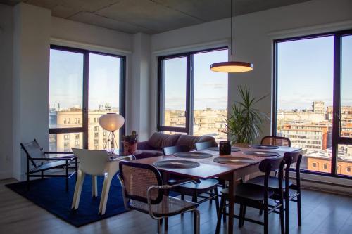 a living room with a table and chairs at Panoramic Apartment in the old port in Montréal