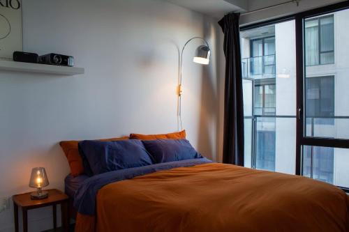 a bed in a room with a large window at Panoramic Apartment in the old port in Montréal