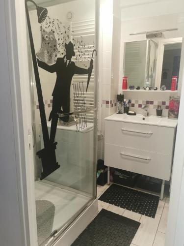 a bathroom with a glass door with a mannequin in a mirror at CHAMBRE CHEZ L'HABITANT - ROOM IN THE OWNER'S APARTMENT in Nice