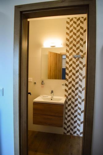 a bathroom with a sink and a mirror at Apartmán Leo in Pavčina Lehota