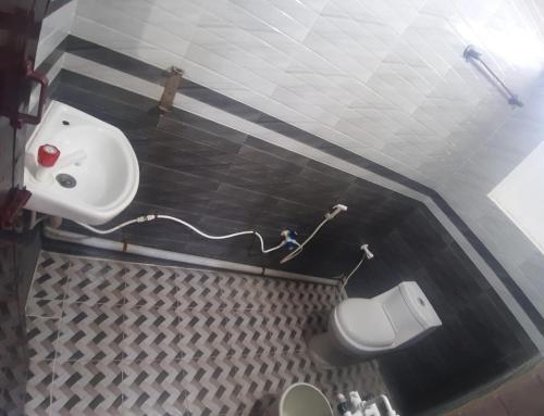 a bathroom with a sink and a toilet at Renu Residency on the way to Isha Yoga Centre- Adiyogi near Maruthamalai in Marudhamalai