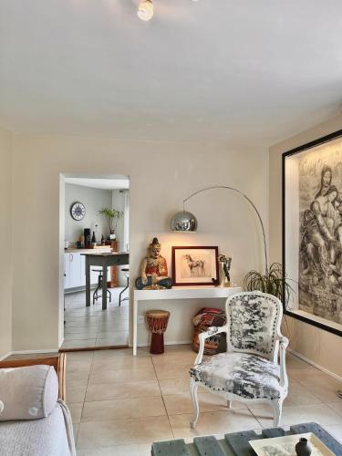 un salon avec une chaise et une table dans l'établissement Charmant 2 pièces dans villa, à Le Rouret