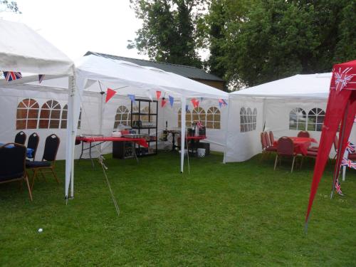 a group of tents with tables and chairs in the grass at Old Oak Tree in Thirsk