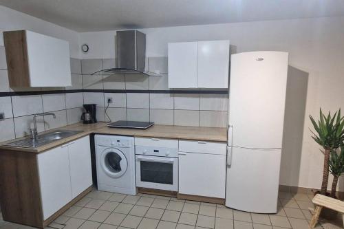 a kitchen with a refrigerator and a washing machine at Au coeur de Vizille in Vizille